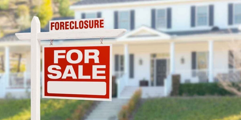 house with foreclosure sign in front yard